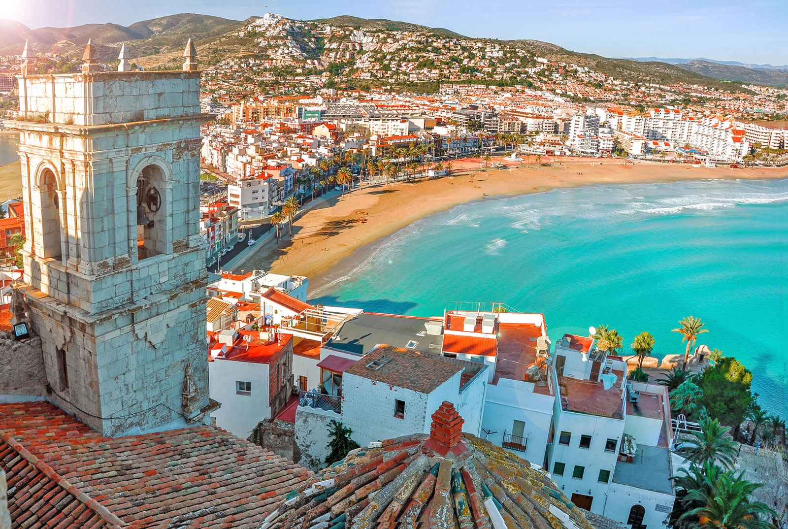Spanish buildings in front of a blue-water bay