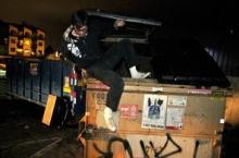 David Giles climbing out of dumpster
