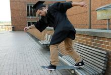 Peter Starrs skateboating in cap and gown