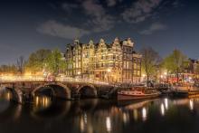 Amsterdam buildings, bridge, and canal at night