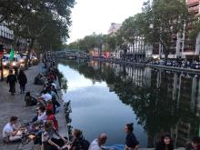people sitting next to the River Seine