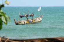 a solitary fishing boat on the ocean in Ghana
