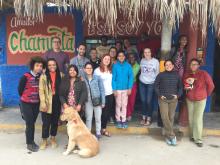 CHID study abroad program students and program directors in front of a store in Peru