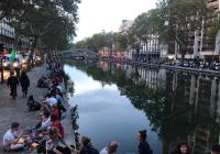 people sitting next to the River Seine