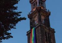 bicycle in front of Amsterdam Westerkerk church tower with rainbow flag banner