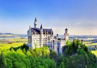 Picture of Neuschwanstein castle, Bavaria, against a blue sky and green landscapte