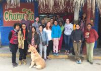 CHID study abroad program students and program directors in front of a store in Peru